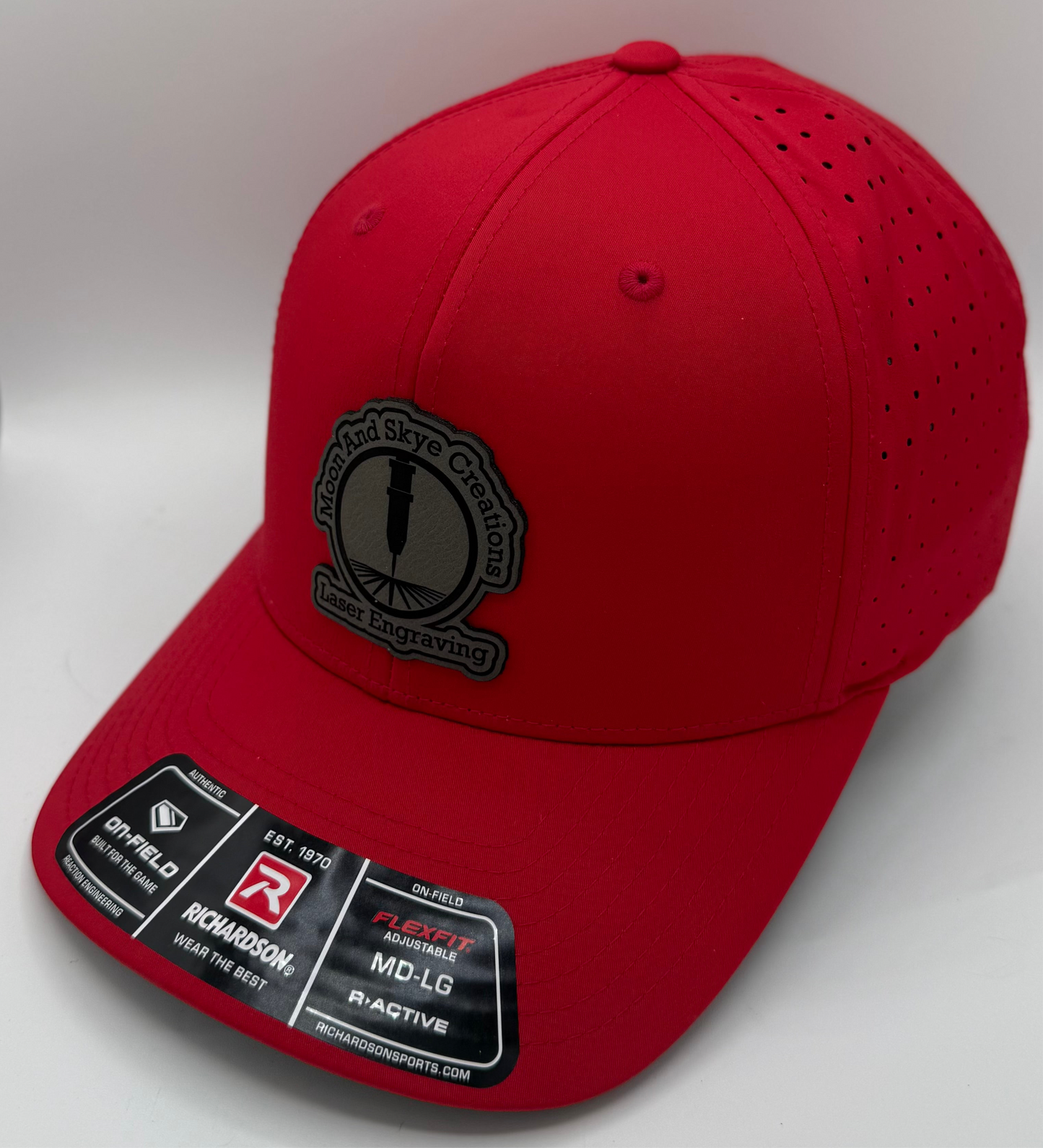 Richardson laser perforated snapback hat in solid red with curved bill and breathable side panels, ideal for custom leather patch branding.