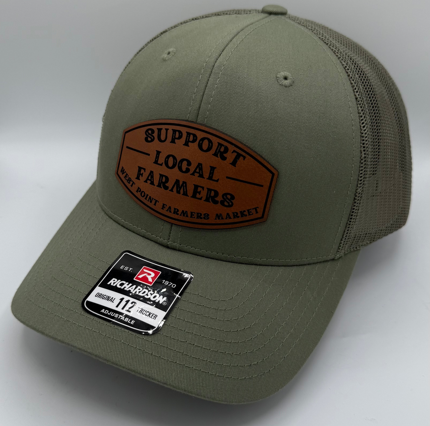 Olive green trucker hat with curved bill and leather patch for customization