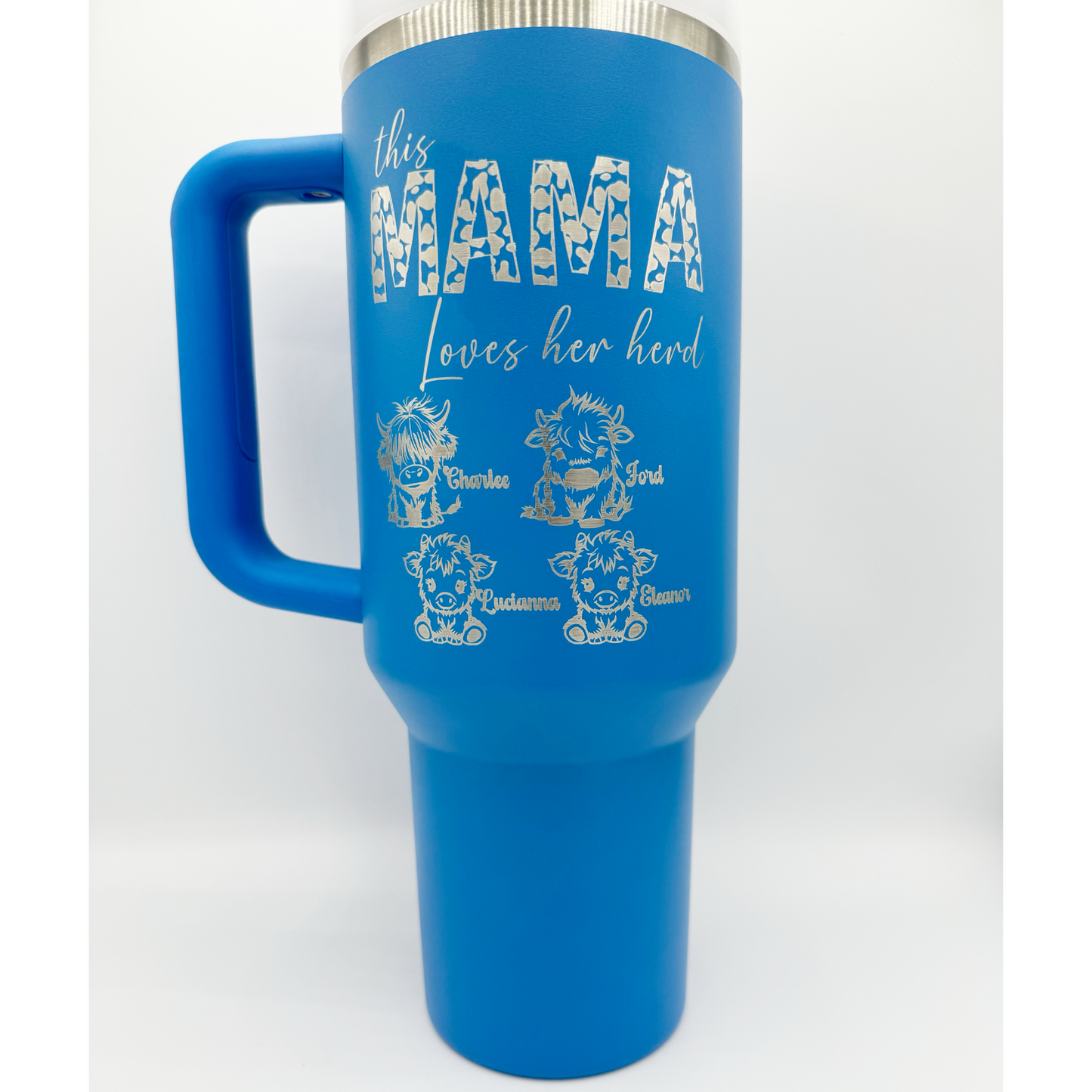 "Custom personalized blue 40oz Stanley tumbler with 'This Mama Loves Her Herd' engraved design, featuring adorable highland cow illustrations and personalized names. Includes a sturdy handle and stainless steel rim, perfect for proud moms on the go."