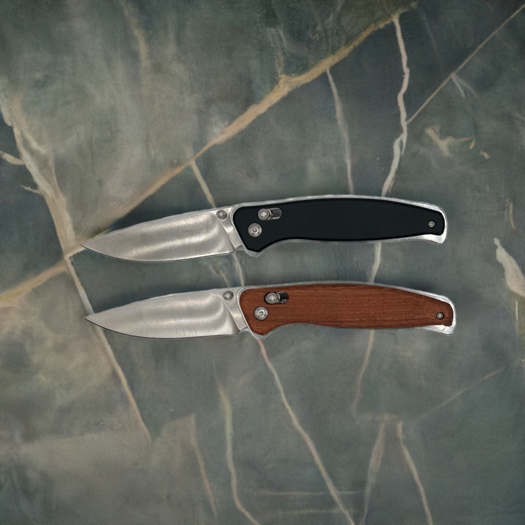 Two personalized Bison River folding pocket knives shown open on a marbled surface—one featuring a black handle and the other a wood handle. Both showcase stainless steel blades and ergonomic designs, perfect for engraving and gifting.
