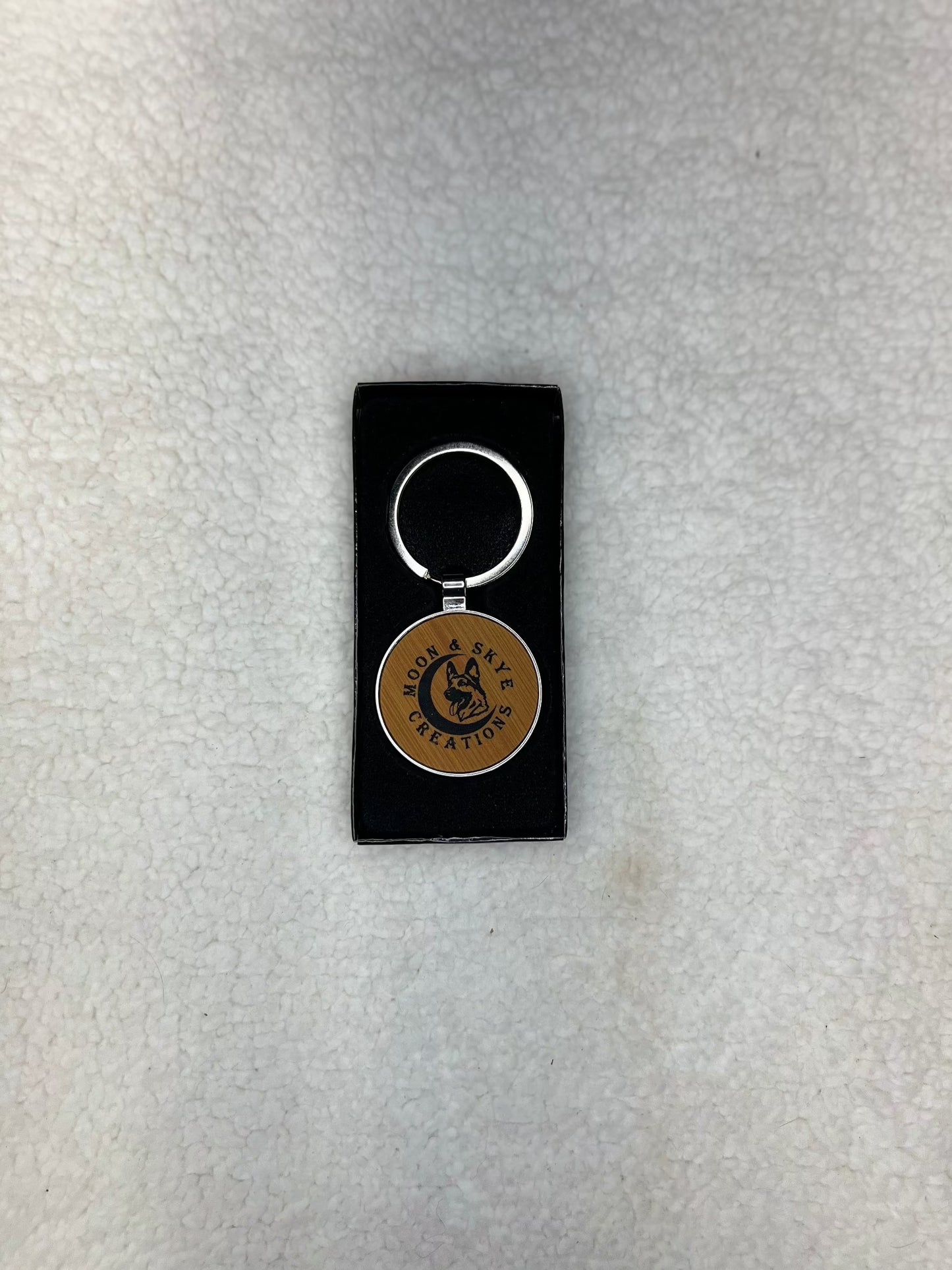 Round metal keychains with leatherette inlay and Moon and Skye Creations LOGO