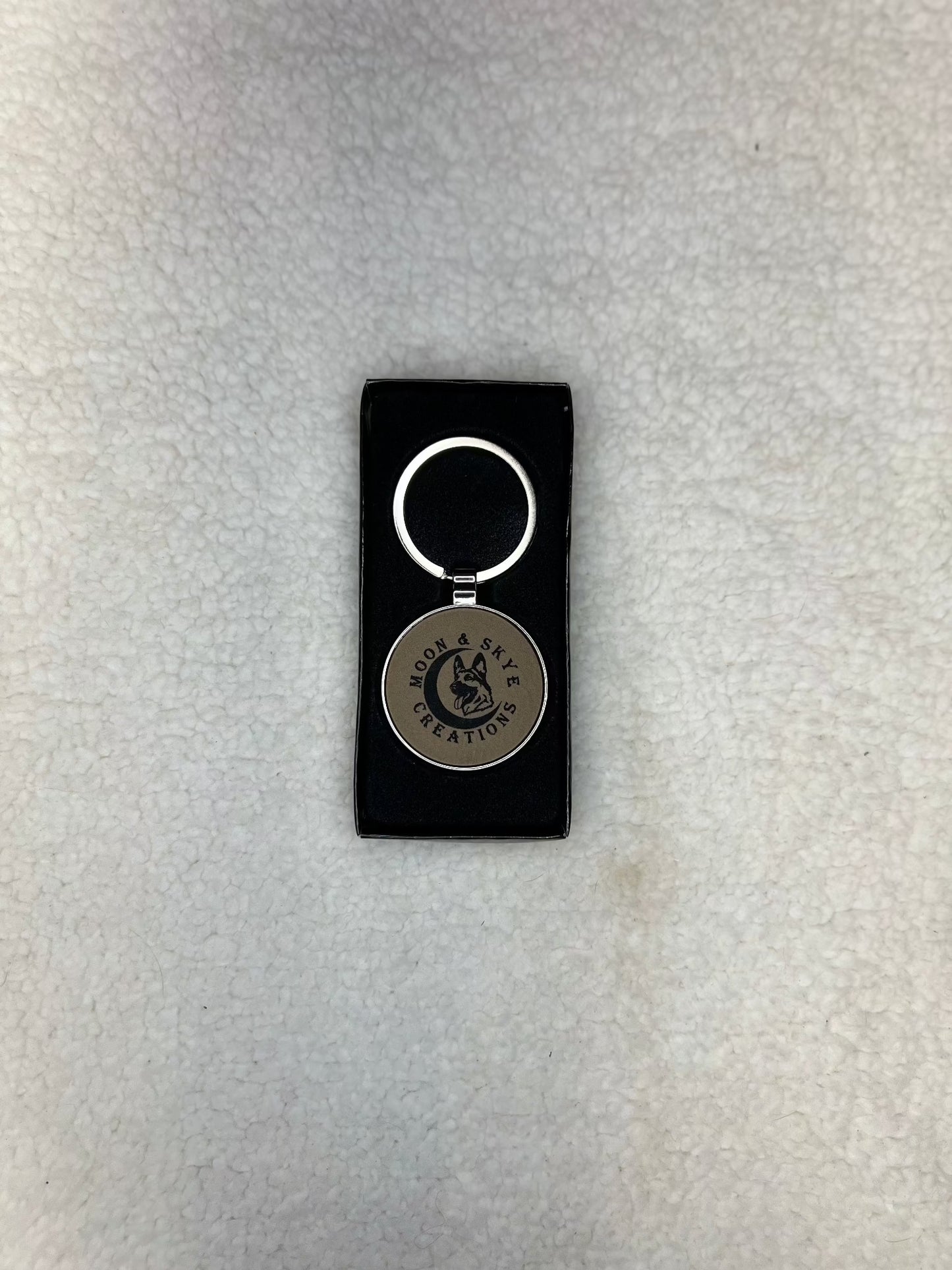 Round metal keychains with leatherette inlay and Moon and Skye Creations LOGO