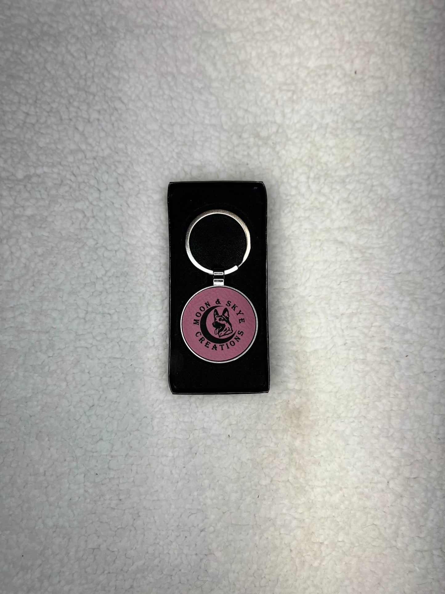 Round metal keychains with leatherette inlay and Moon and Skye Creations LOGO