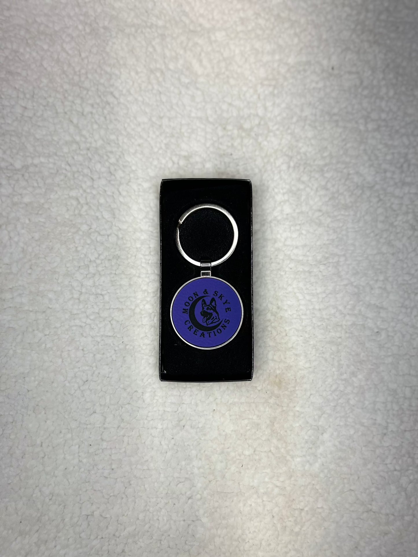 Round metal keychains with leatherette inlay and Moon and Skye Creations LOGO