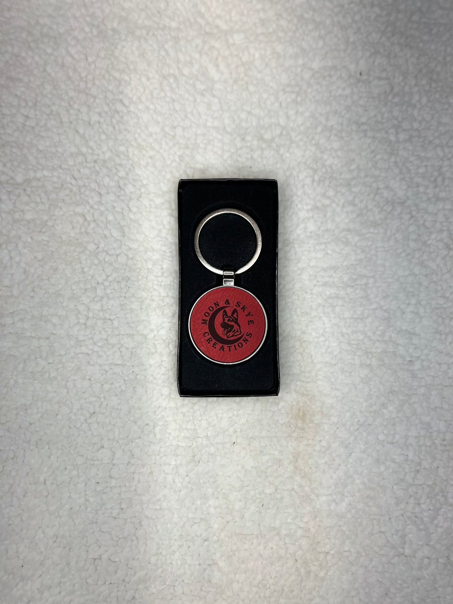 Round metal keychains with leatherette inlay and Moon and Skye Creations LOGO