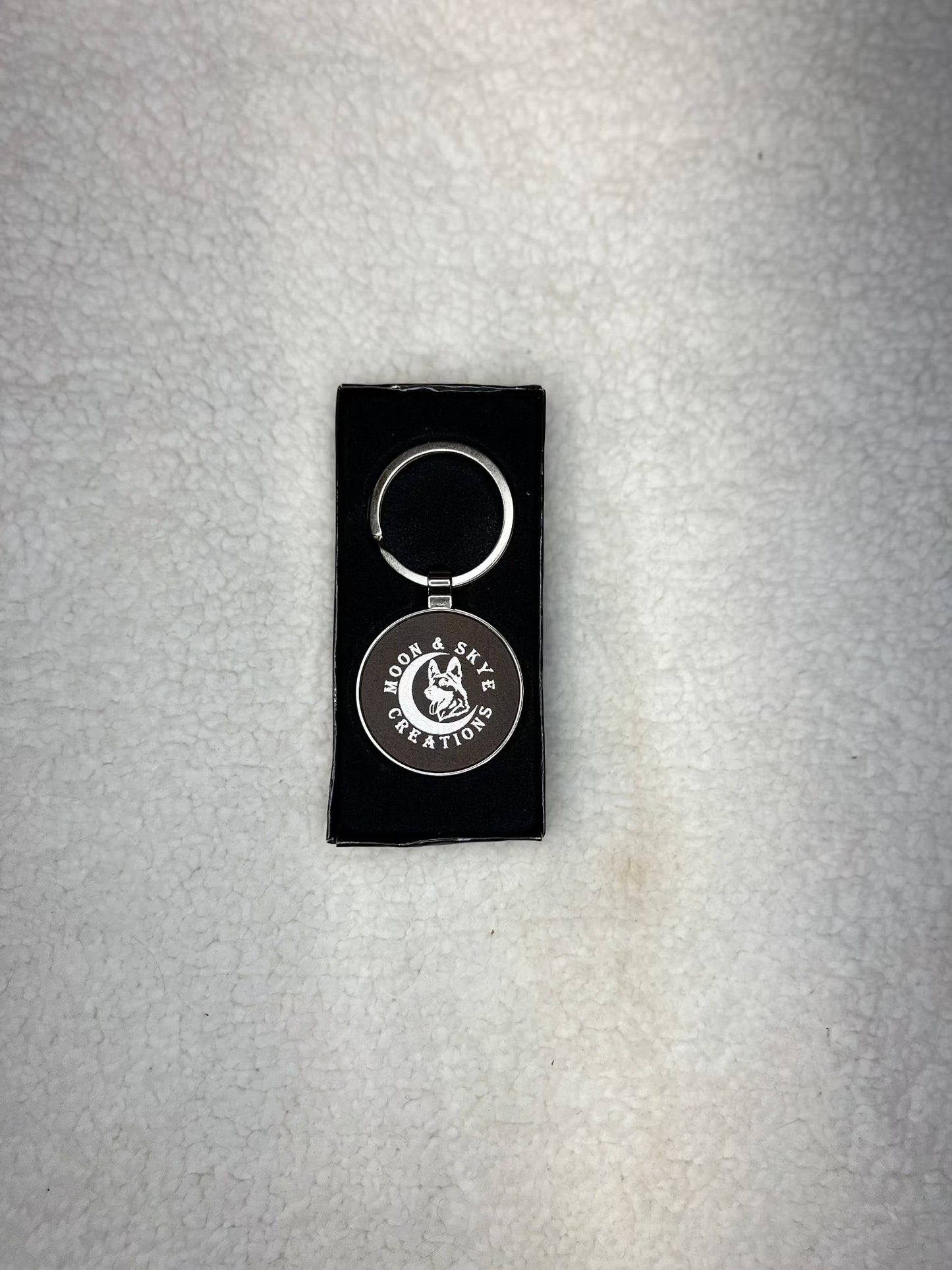 Round metal keychains with leatherette inlay and Moon and Skye Creations LOGO