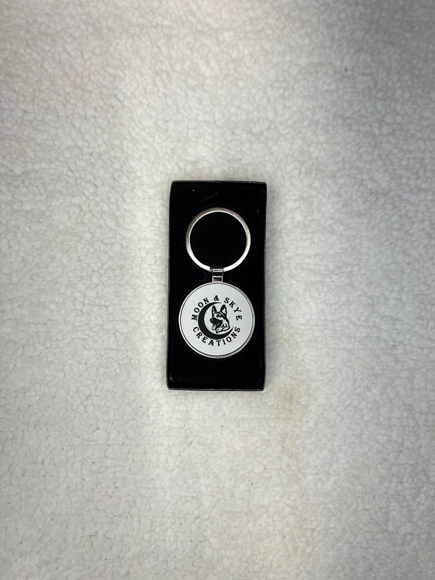 Round metal keychains with leatherette inlay and Moon and Skye Creations LOGO