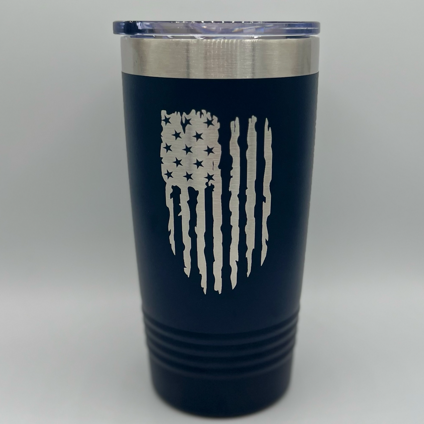 "Navy blue 20 oz Polar Camel tumbler with laser-engraved distressed American flag design — patriotic stainless steel travel mug with clear lid, ideal for personalized gifts or outdoor enthusiasts."