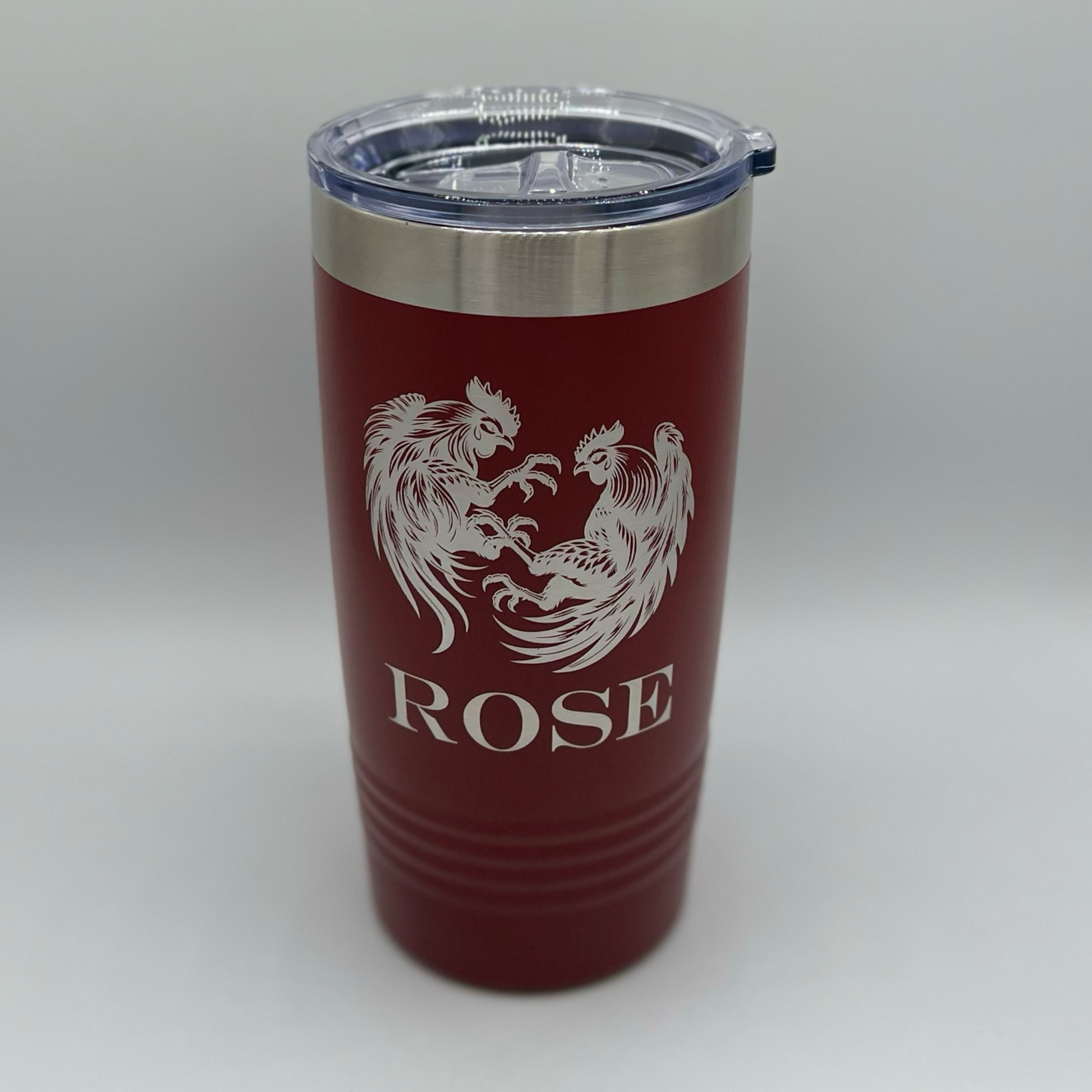 "Maroon 20 oz Polar Camel tumbler with custom laser-engraved fighting roosters design and personalized name 'ROSE' — durable stainless steel travel mug with lid, perfect for gifts or promotional items."
